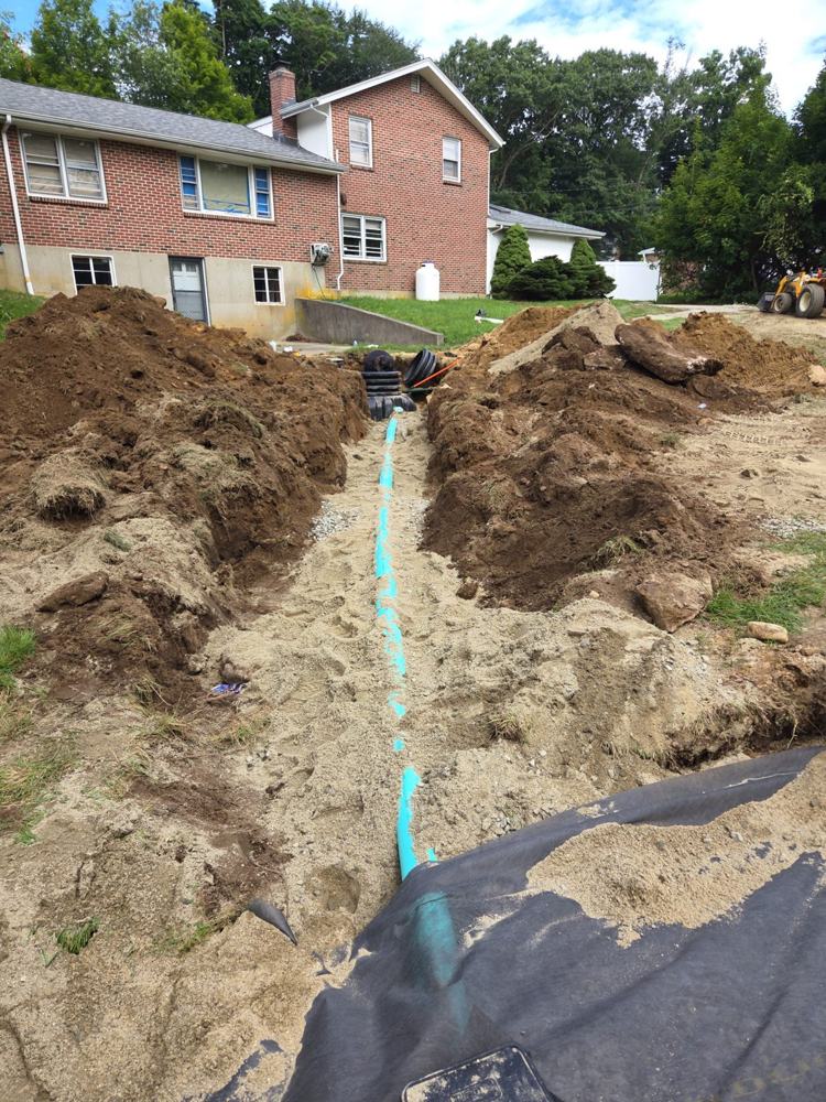 New tank with risers and PVC line bedded in sand